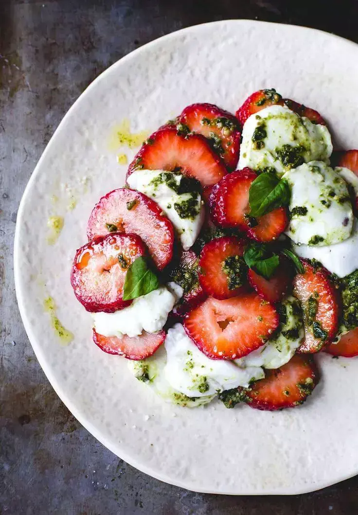7. Pesto Strawberry Caprese Salad by Heartbeet Kitchen is quick to put together yet absolutely delicious. You'll fall in love with this unique combination!
