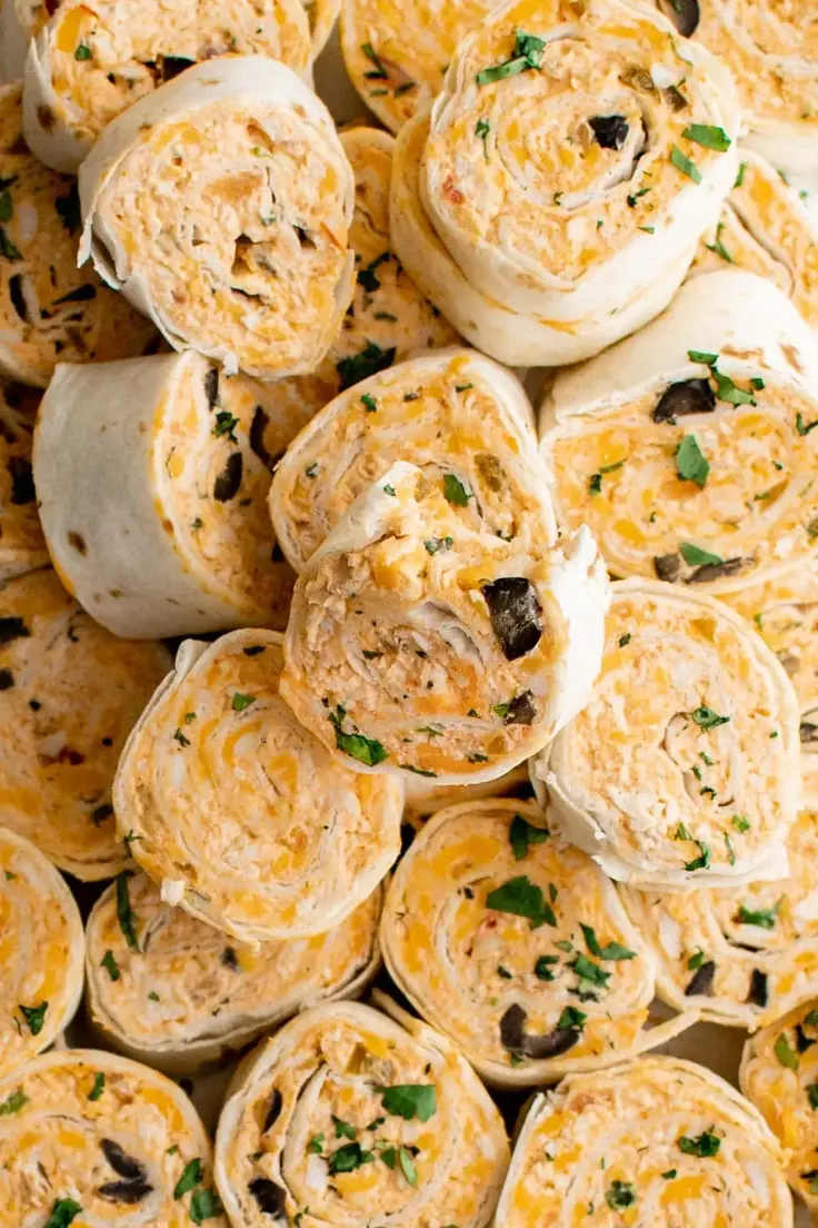 These Mexican Tortilla Pinwheels are made with a mix of different cheeses such as Colby cheese, cream cheese, cheddar cheese, and shredded chicken. Flavored with taco seasoning, cilantro, green onions, olives, and salsa.