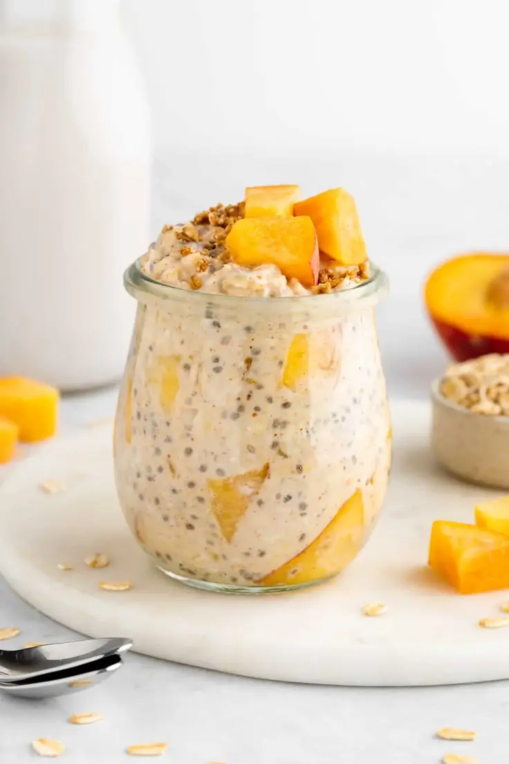Make Ahead Breakfast Bowls - Peaches and Cream Overnight Oats by Purely Kaylie is vegan, gluten-free, dairy-free, and made with no refined sugar.
