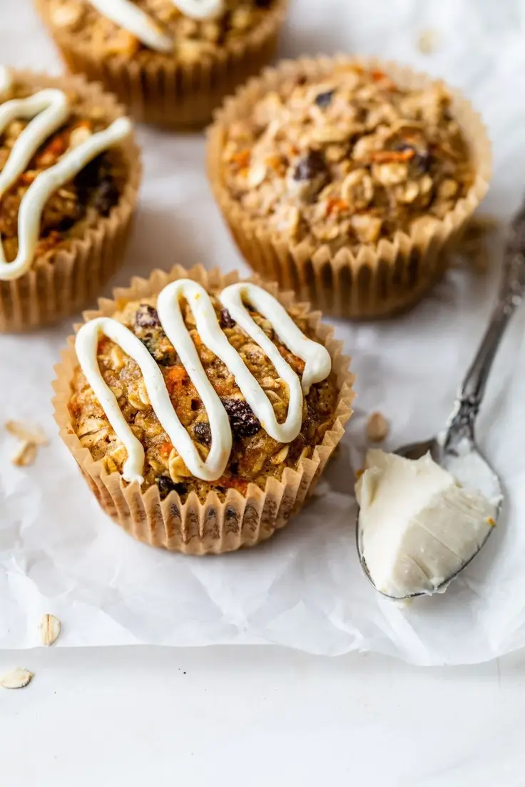 Easy Make Ahead Carrot Cake Baked Oatmeal Cups by Clean and Delicious is naturally sweetened with pure maple syrup with a light cream cheese icing.

