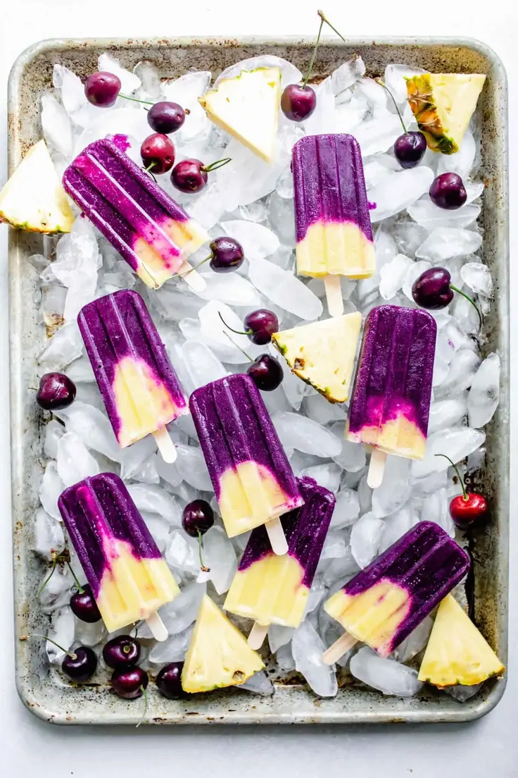 4. Cherry Pineapple Popsicles by Platings and Pairings
